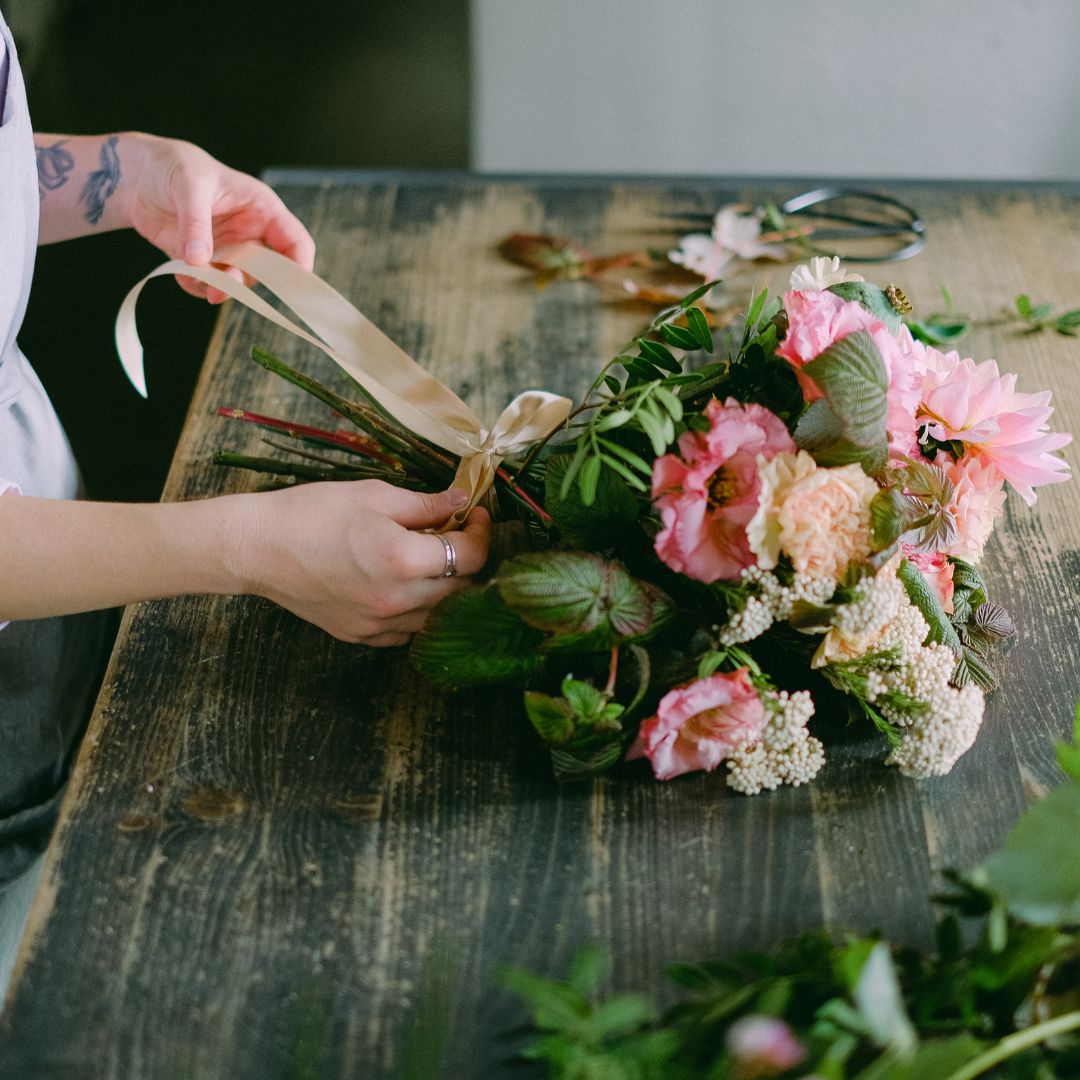An employee putting together a flower arrangement